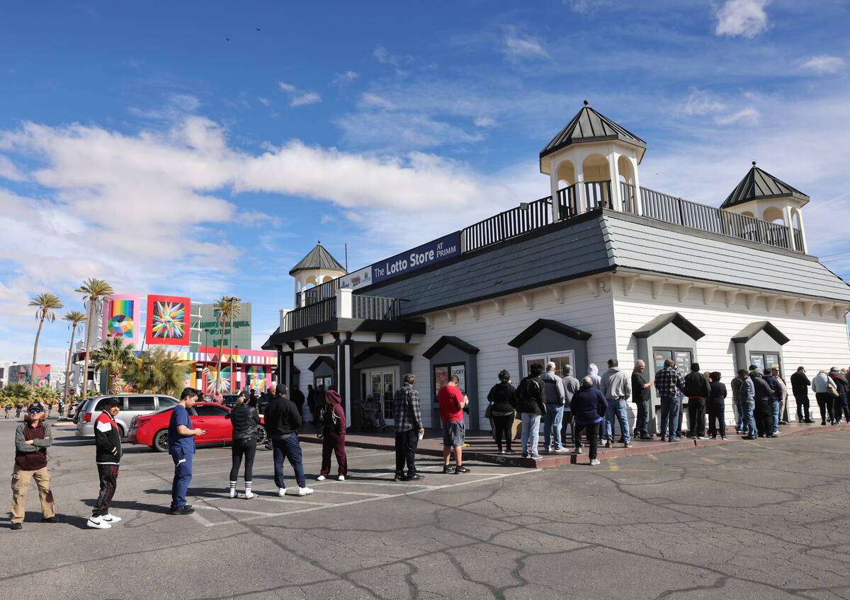 People wait in line to buy lottery tickets at the Lotto Store just across the Nevada/California ...