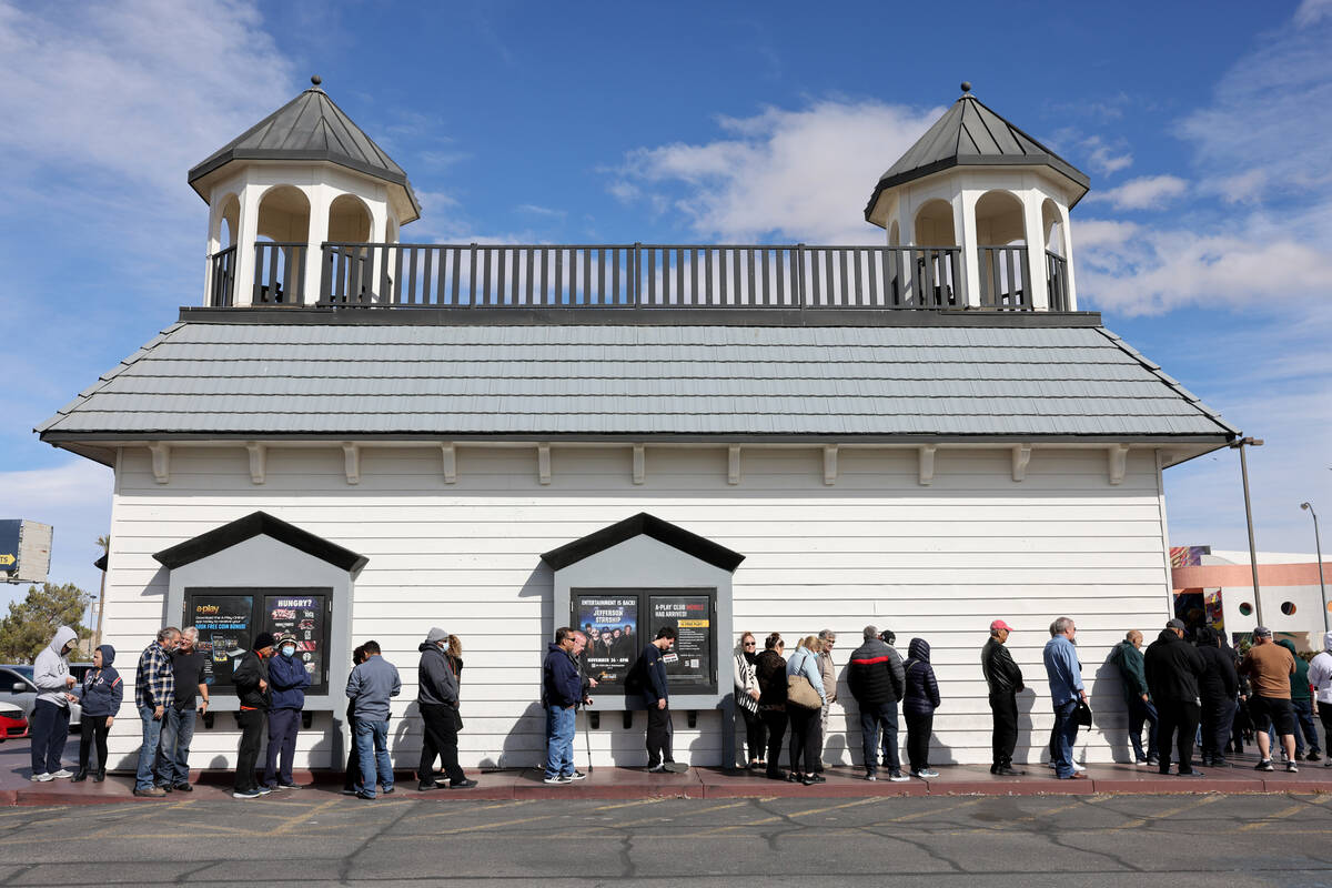People wait in line to buy lottery tickets at the Lotto Store just across the Nevada/California ...