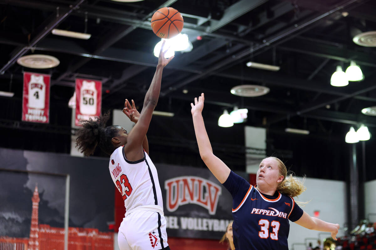 UNLV's Desi-Rae Young (23) takaes a shot over Pepperdine's KK Brodie (33) during the first half ...