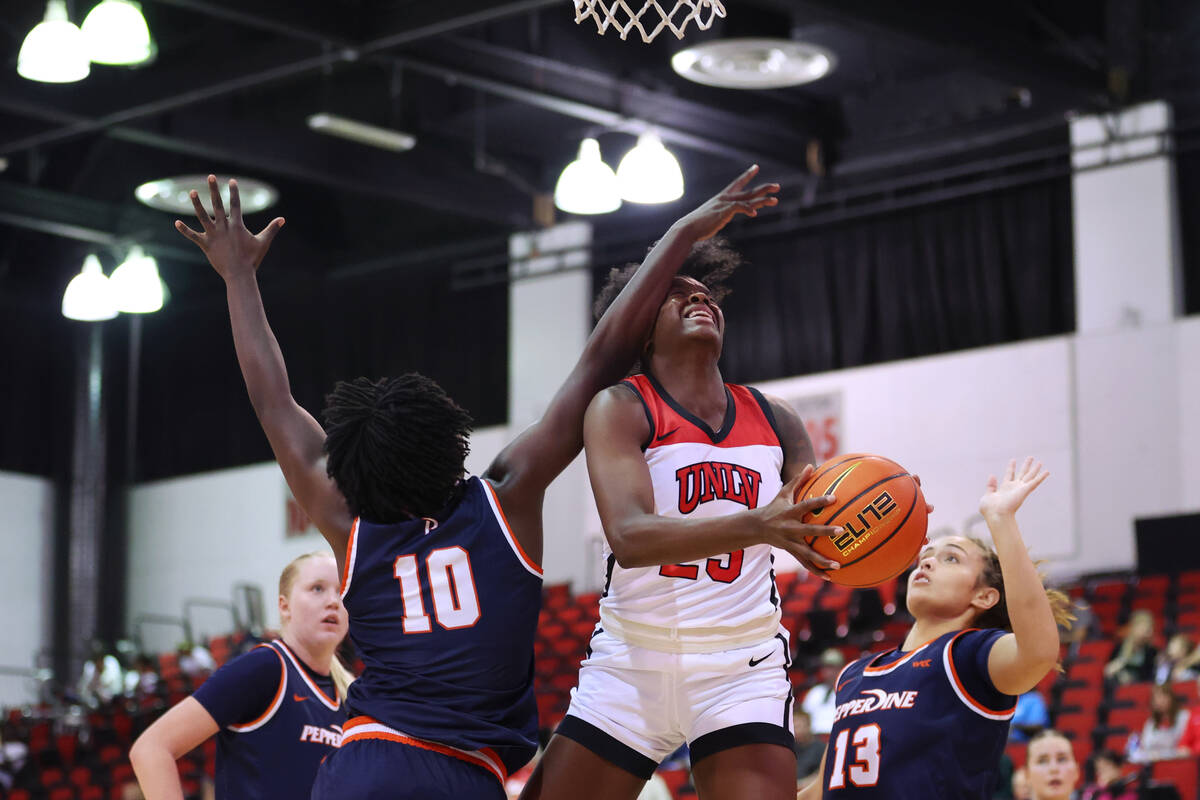 UNLV's Desi-Rae Young (23) is fouled by Pepperdine's Jane Nwaba (10) while attempting a shot du ...