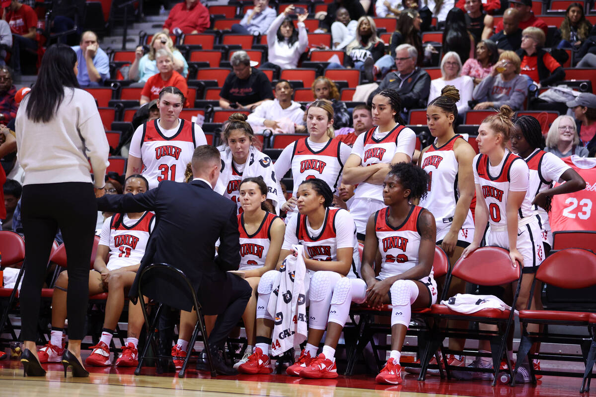 UNLV players listen to their coaching staff during a timeout in the second half of a women's ba ...