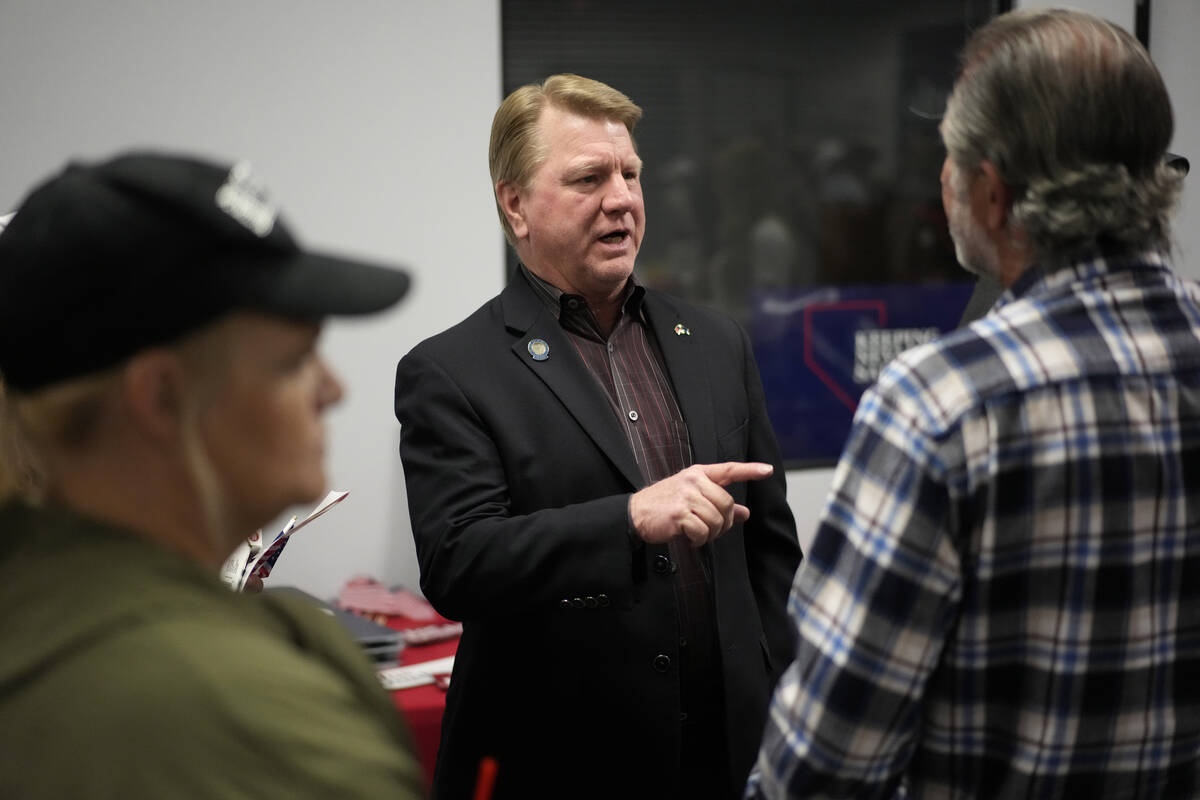 Jim Marchant, center, GOP nominee for secretary of state in Nevada, speaks with people at a cam ...