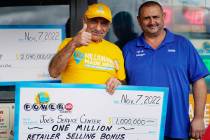 Business owner Joe Chahayed holds a check with his son, Joe Chahayed, Jr., as they pose for a p ...
