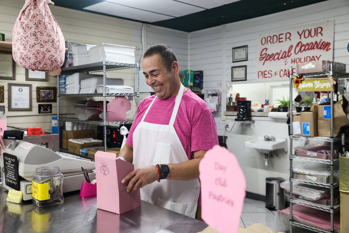 Juan Medina assists customers at his shop, Mrs. Williams’ Diabetic Delights, where the b ...