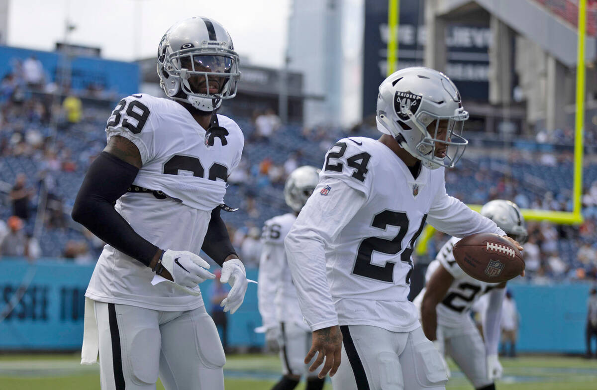 Raiders cornerback Nate Hobbs (39) and safety Johnathan Abram (24) work together before an NFL ...
