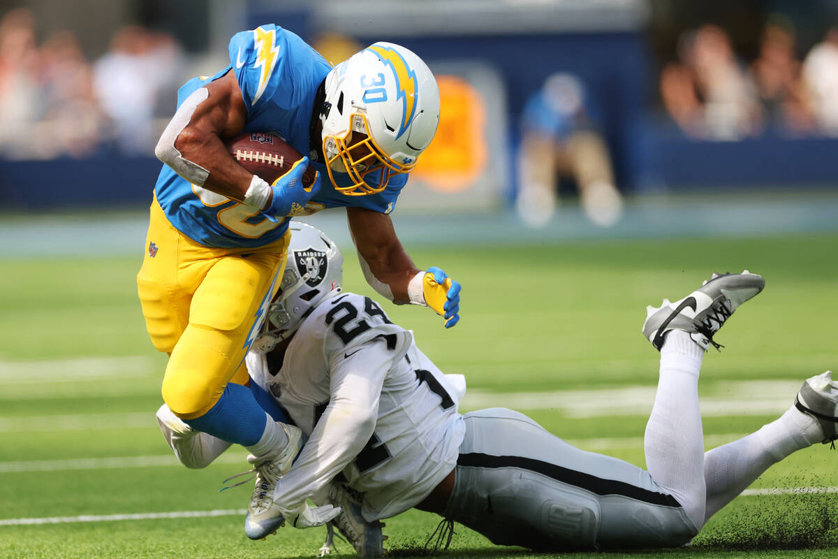 Raiders safety Johnathan Abram (24) tackles Los Angeles Chargers running back Austin Ekeler (30 ...