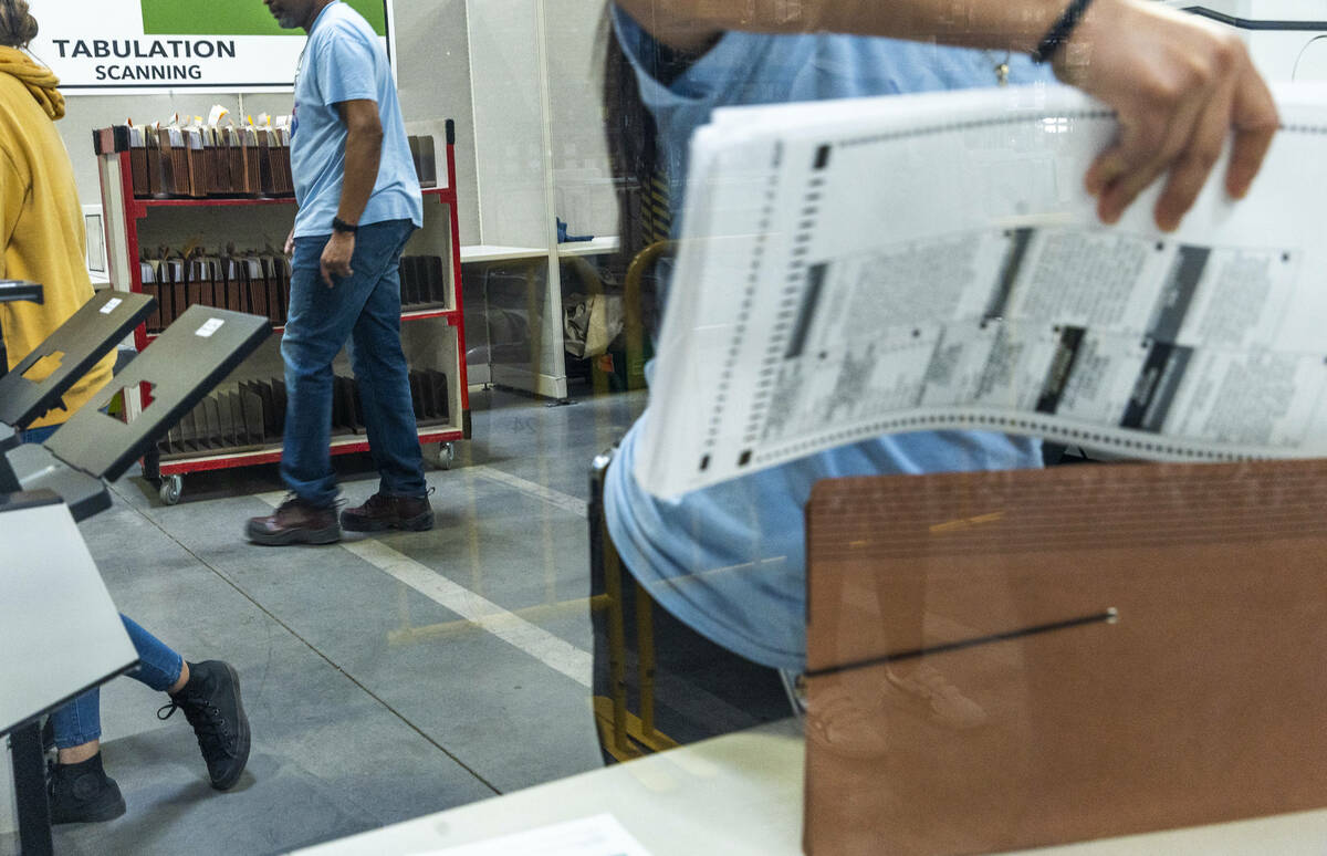 Workers continue sorting ballots for final tabulations at the Clark County Election Department ...