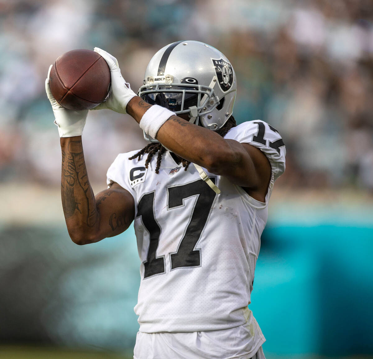 Raiders wide receiver Davante Adams (17) stays loose on the sideline during the second half of ...