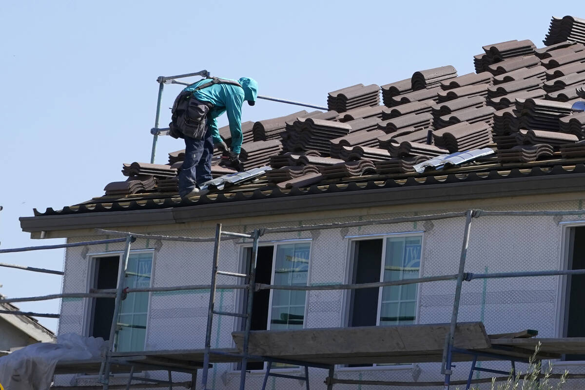 File - Work is performed on the roof of a home under construction in Folsom, Calif. Wednesday, ...