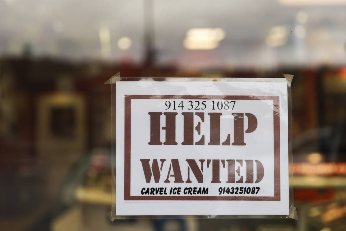 A help wanted sign is displayed in a storefront, Tuesday, Nov. 1, 2022, in Bedford, N.Y. Employ ...