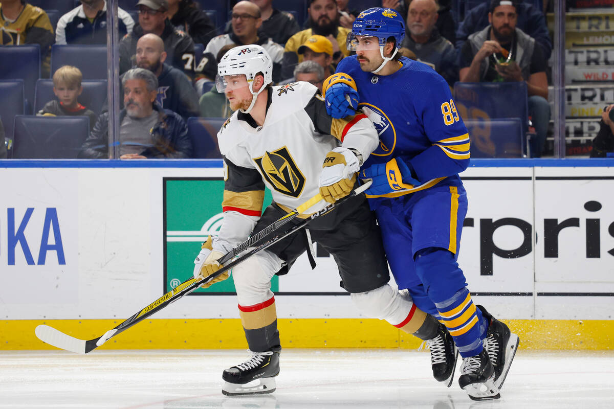 Vegas Golden Knights center Jack Eichel (9) and Buffalo Sabres right wing Alex Tuch (89) collid ...