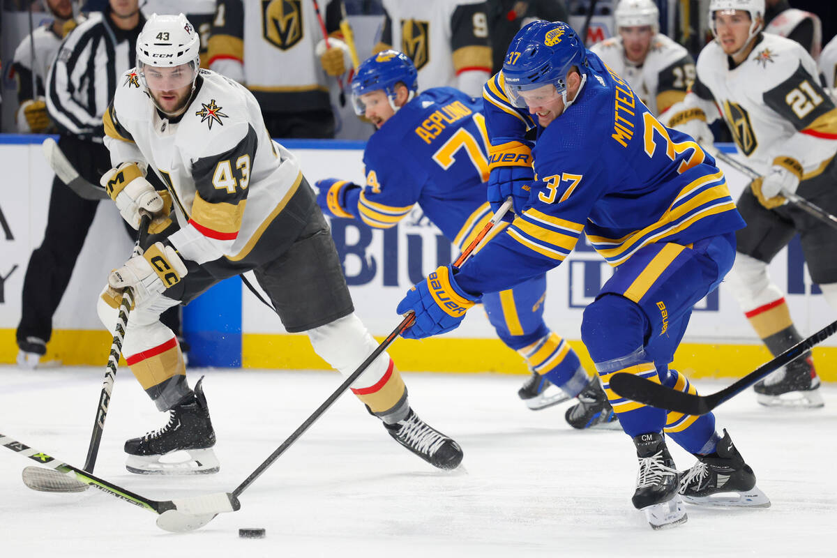Buffalo Sabres center Casey Mittelstadt (37) takes the puck from Vegas Golden Knights center Pa ...