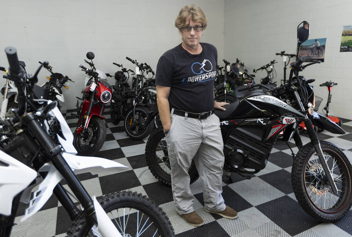 John Reagan, owner of E-Power Sport, poses for a portrait at his e-bike shop showroom floor in ...