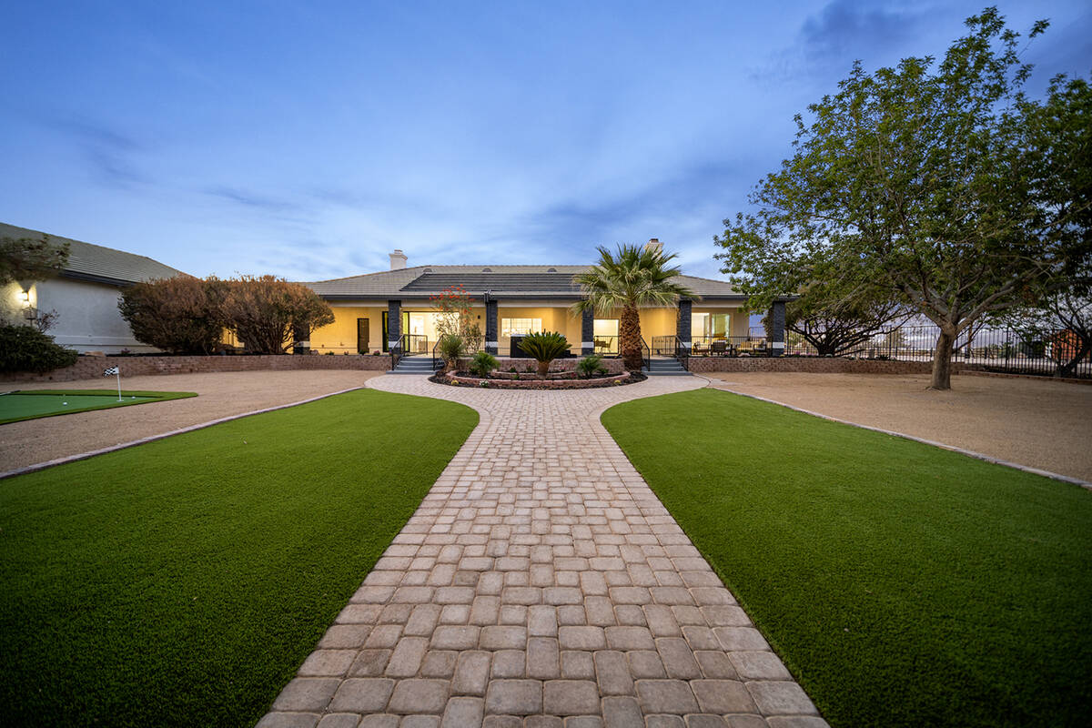 The grounds have lush landscaping and mature fruit trees. (Sotheby’s International Realty)