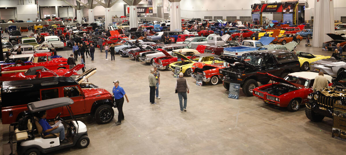 People check out cars during Mecum Las Vegas auction at the Las Vegas Convention Center, Thursd ...