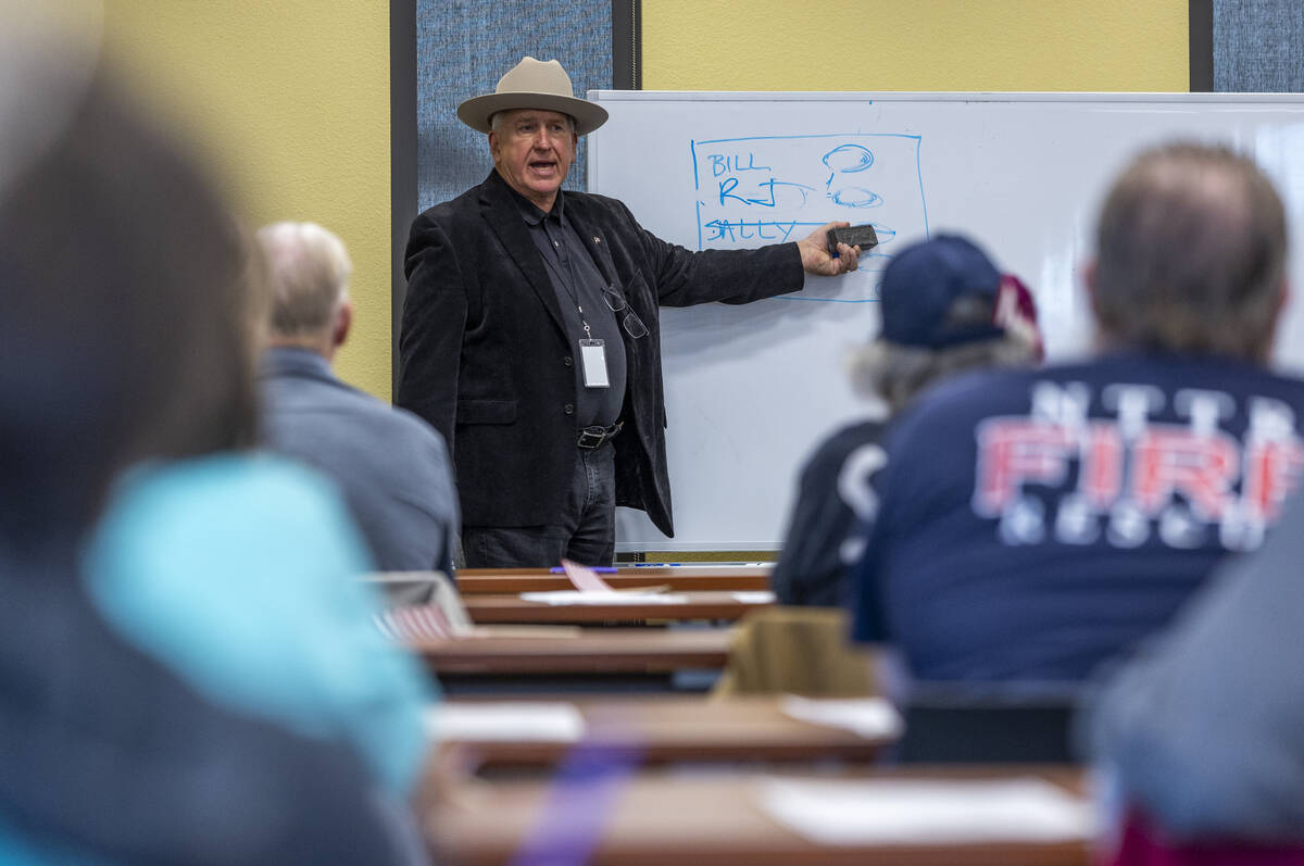 Nye County Clerk Mark Kampf instructs volunteers on the correct ballot markings as they resume ...