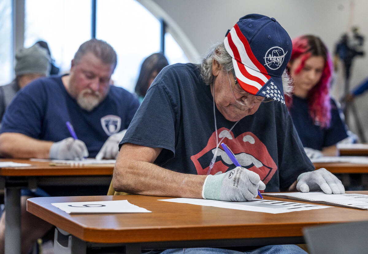 Volunteers resume hand counting ballots in Nye County at the Valley Conference Center on Thursd ...