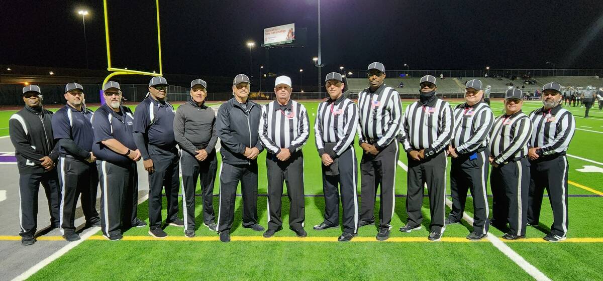 Referee John Hathaway (Marines), white cap, center, headed an officiating and game management c ...