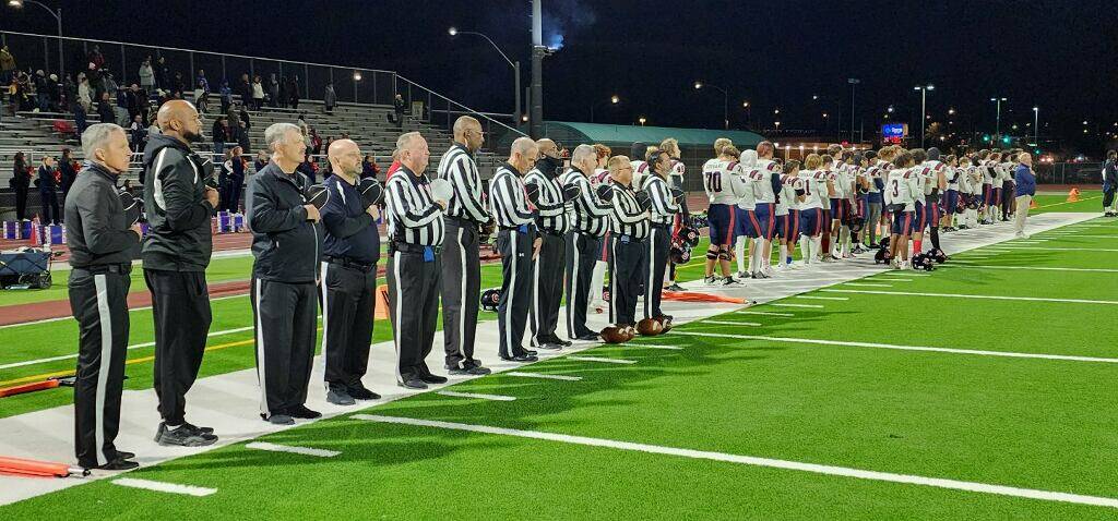 Referee John Hathaway, white cap, fifth from left, headed an officiating and game management cr ...