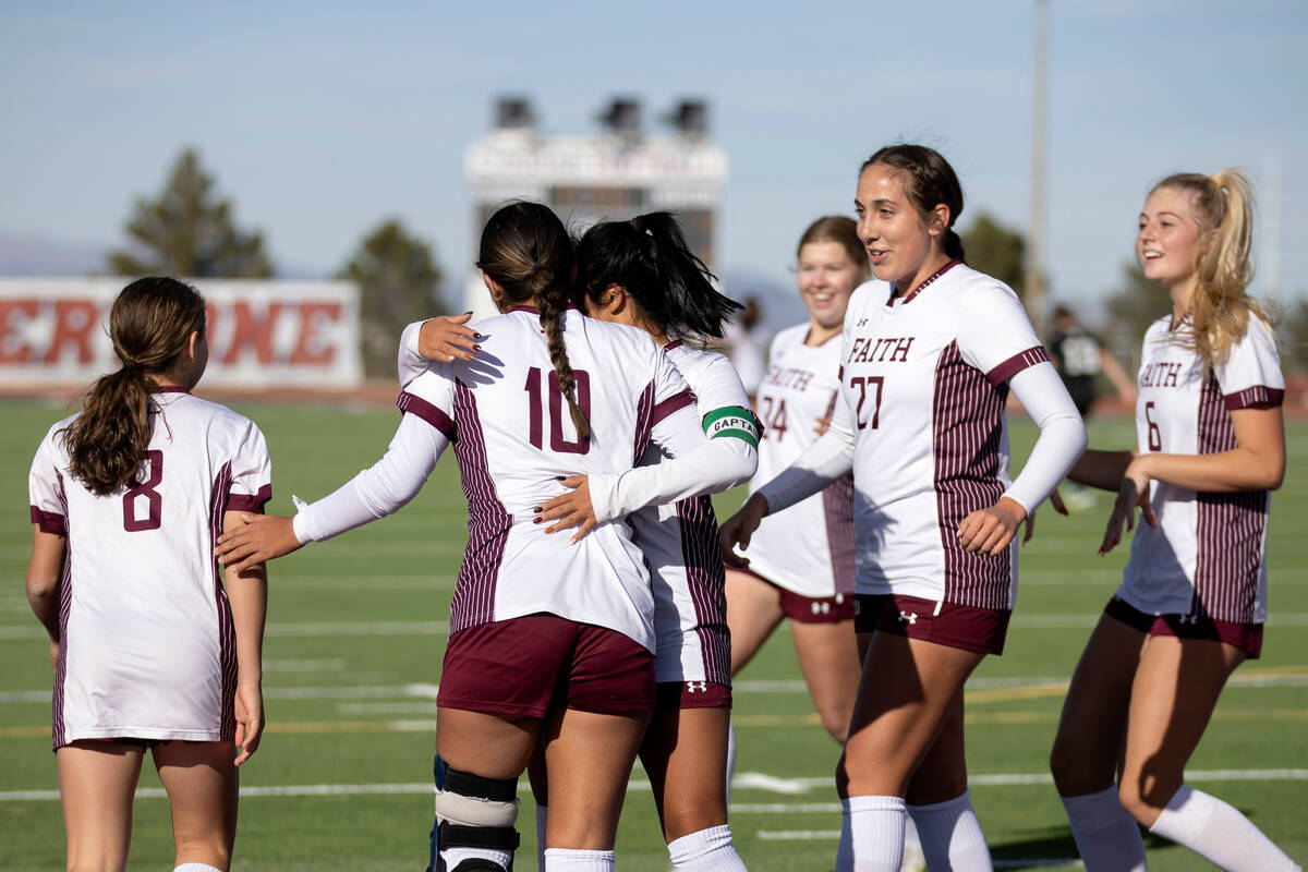 Faith Lutheran gathers to celebrate a goal during a Class 5A girls high school soccer state sem ...