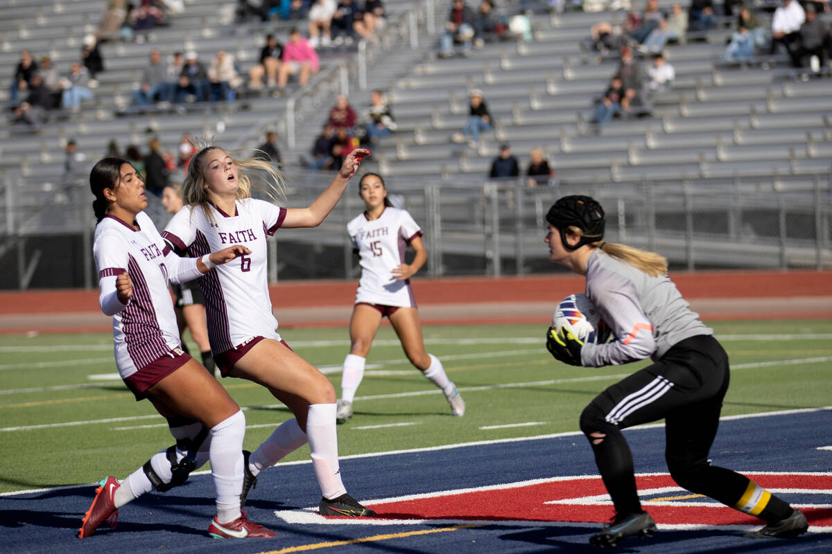 Galena’s Elizabeth Mehrtens (0) saves a shot on goal while Faith Lutheran’s Andre ...