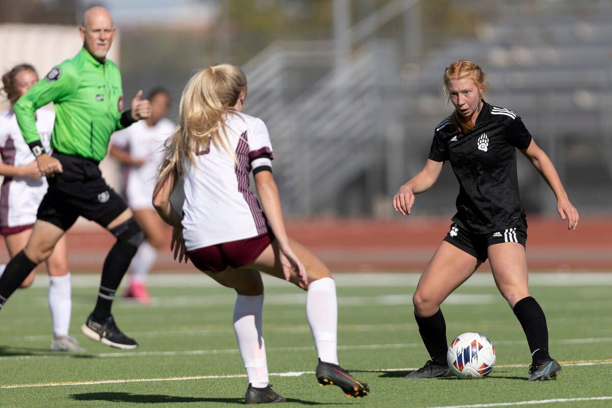 Galena’s Katherine Muff, right, dribbles against Faith Lutheran’s Brooklyn Maier ...