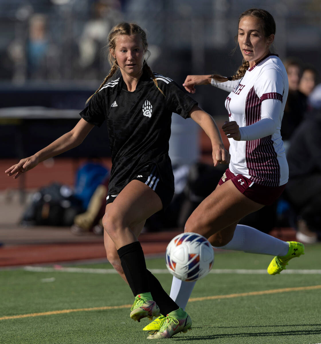 Galena’s Nyla Hensley (16) passes while Faith Lutheran’s Madeline Mariani, right, ...