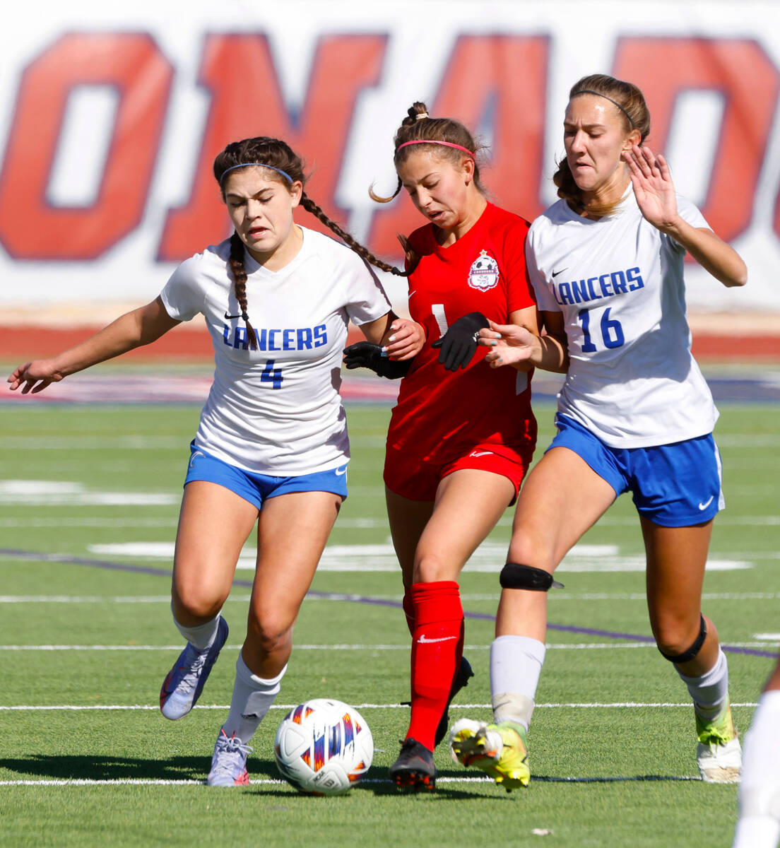 Coronado High's Lily Fama (1) is sandwiched between McQueen's High Allysa Allan (4) and Caitli ...