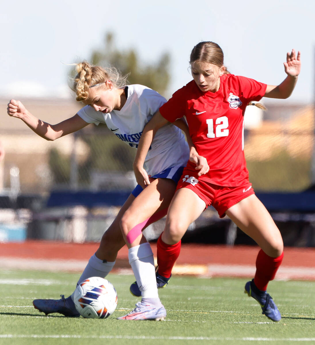 Coronado High's Tia Garr (12) and McQueen's High Avery Hayes (20) fight the ball during the fir ...