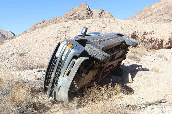 The overturned truck driven by the suspected car thieves. A BLM trainee shot seven rounds into ...