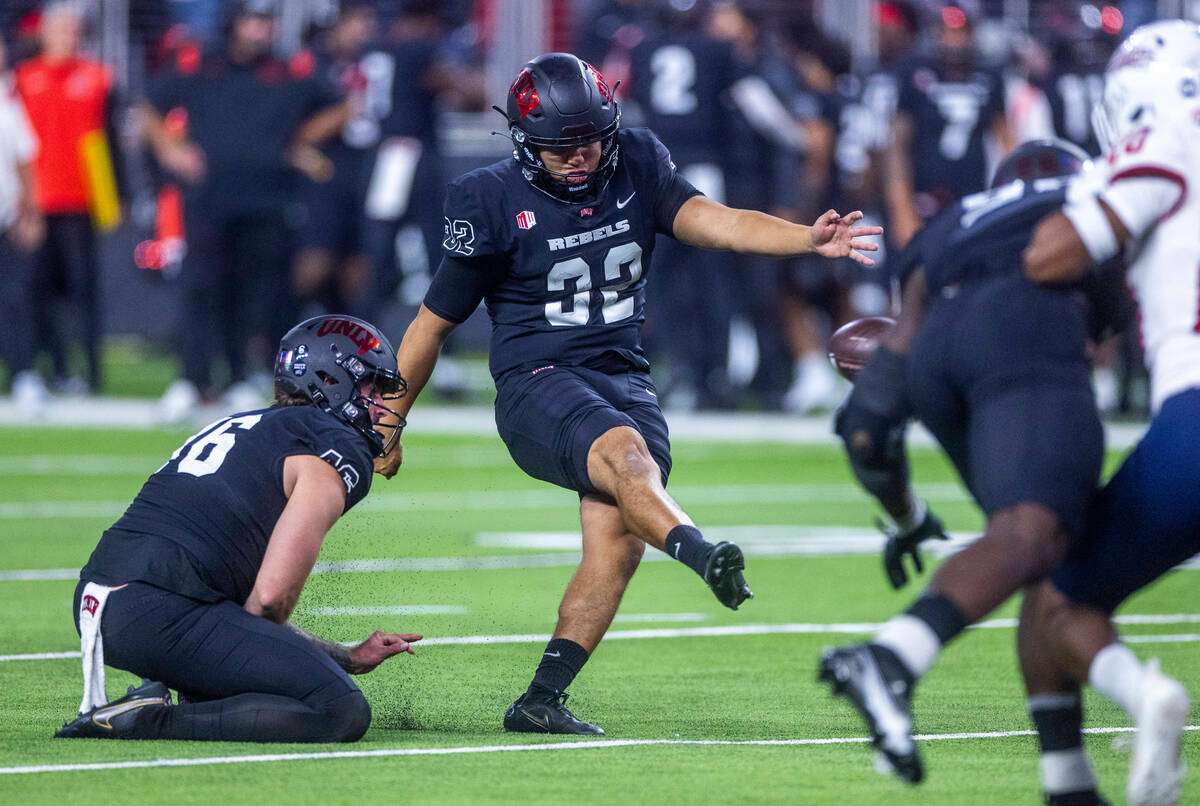 UNLV Rebels place kicker Daniel Gutierrez (32) makes another successful kick over the Fresno St ...