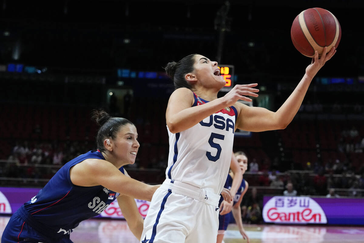 United States' Kelsey Plum takes a shot at goal as Serbia's Sasa Cado attempts to block during ...