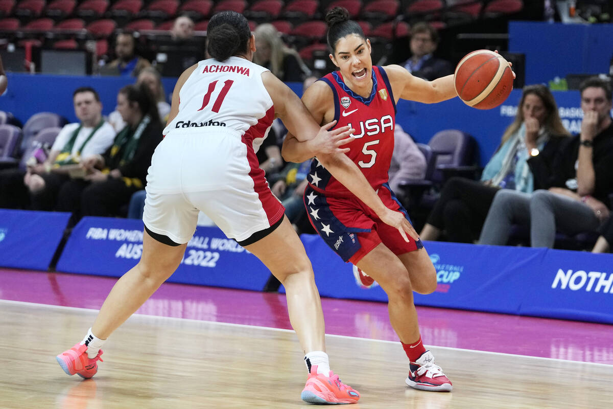 United States' Kelsey Plum, right goes around Canada's Natalie Achonwa during their semifinal g ...