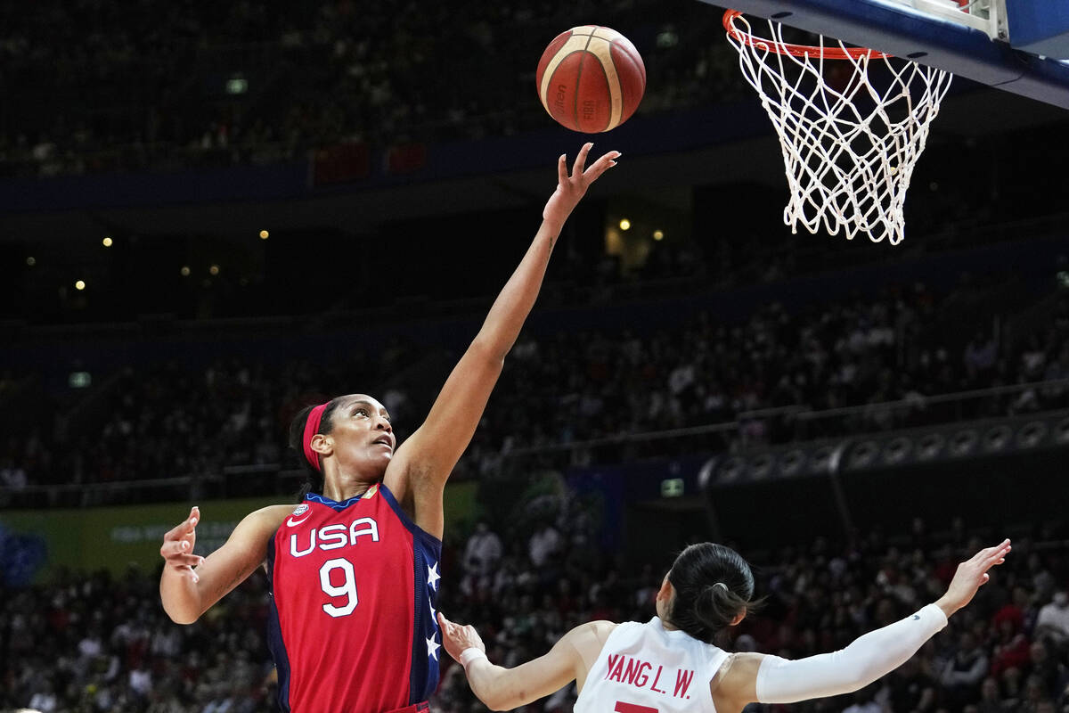 United States' A'ja Wilson, left, shoots over China's Yang Liwei during their gold medal game a ...