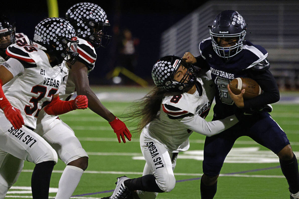 Shadow Ridge’s Coen Nicholas Coloma (8) is tackled by Las Vegas’ Kawika Lopez, (8 ...