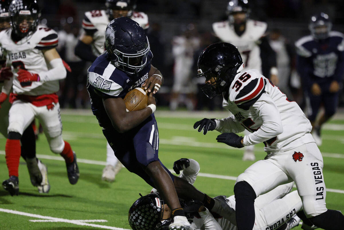 Las Vegas’ Kawika Lopez (8), bottom, and Darientae Fryman (35) cannot stop Shadow Ridge& ...