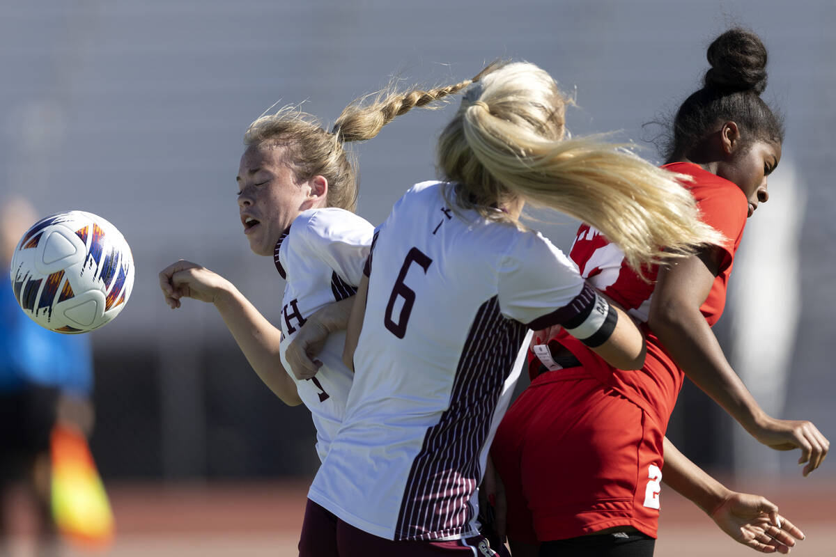 Faith Lutheran’s McKenna Beckett, left, and Brooklyn Maier (6) head the ball against Cor ...