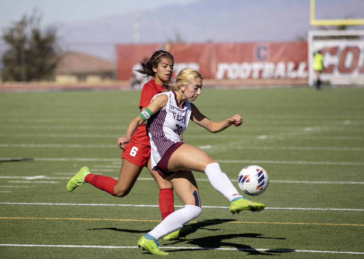 Faith Lutheran’s Ava Gardner (20) passes while Coronado’s Milan Cordone (6) runs ...