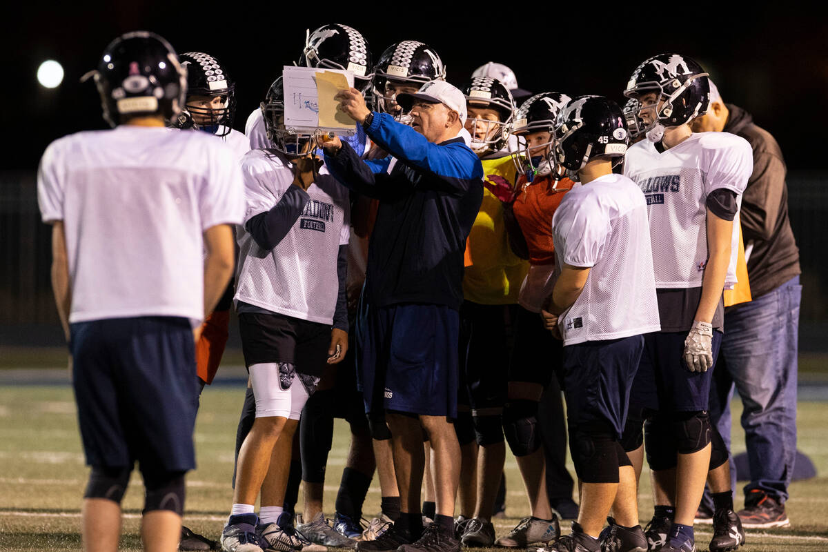 The Meadows High School defensive coordinator Rodney Vollan discusses the game plan with his pl ...