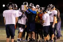 The Meadows High School defensive coordinator Rodney Vollan discusses the game plan with his pl ...