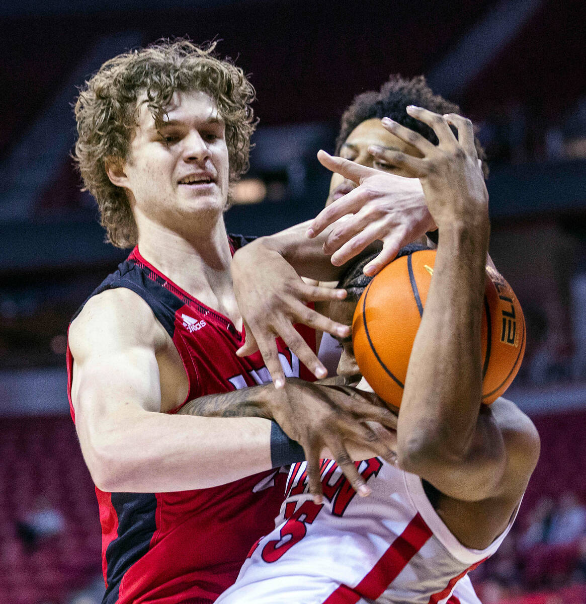 UNLV Rebels guard Luis Rodriguez (15) battles for a loose ball with Incarnate Word Cardinals fo ...