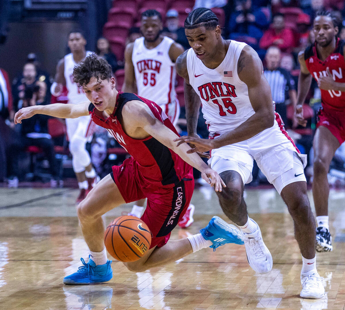 Incarnate Word Cardinals guard Niki Krause (12) and UNLV Rebels guard Luis Rodriguez (15) has a ...
