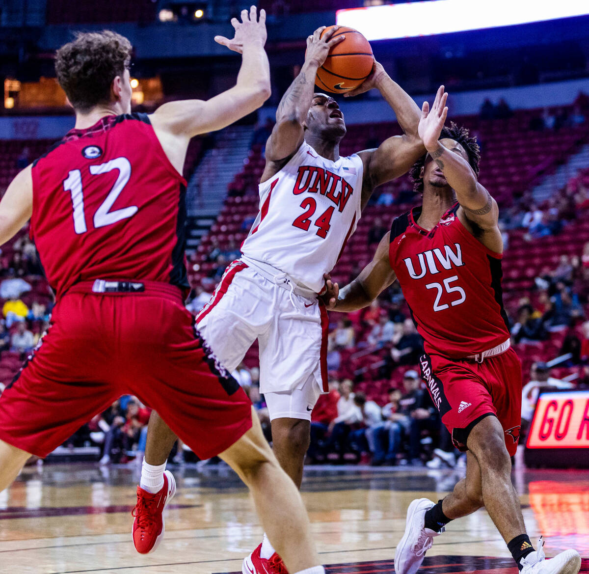 UNLV Rebels guard Jackie Johnson III (24) splits the defense of Incarnate Word Cardinals guard ...