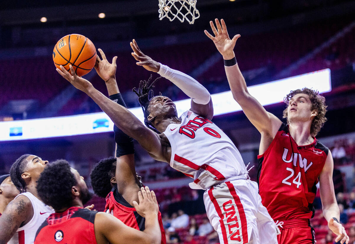 UNLV Rebels forward Victor Iwuakor (0) powers up for a basket over Incarnate Word Cardinals gua ...