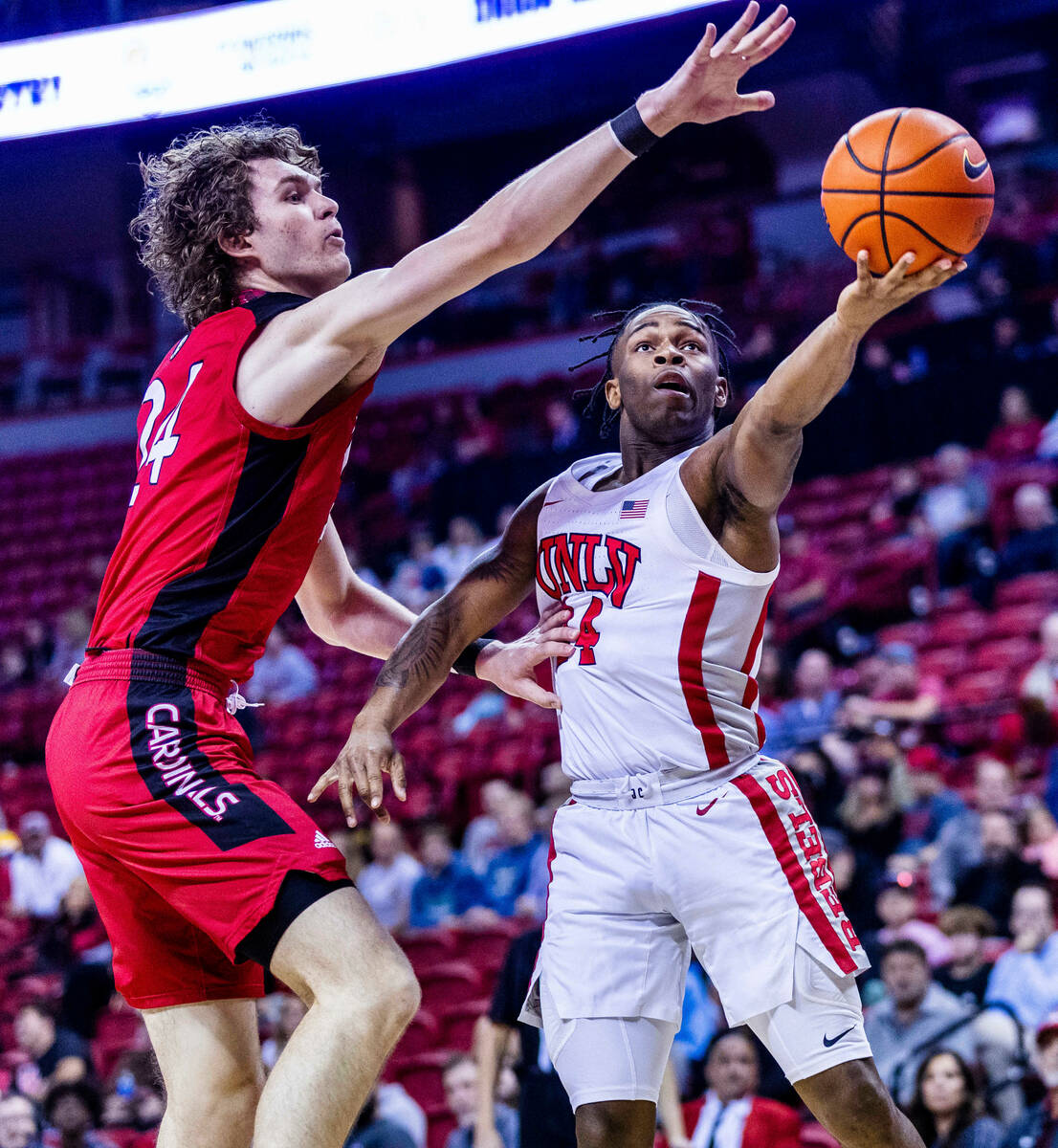 UNLV Rebels guard Jackie Johnson III (24) extends past Incarnate Word Cardinals forward Benjami ...