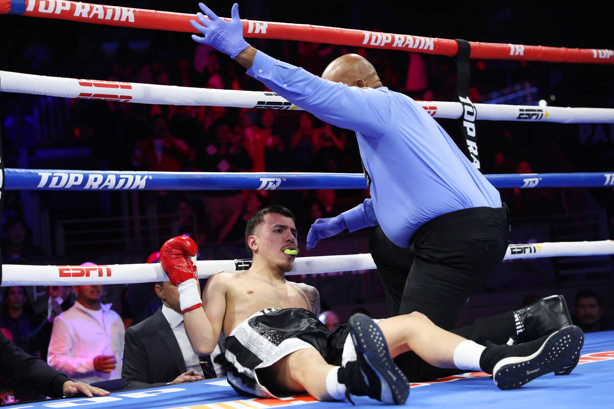 Julio Cesar Martinez is knocked out by Emiliano Fernando Vargas, not pictured, in the second ro ...