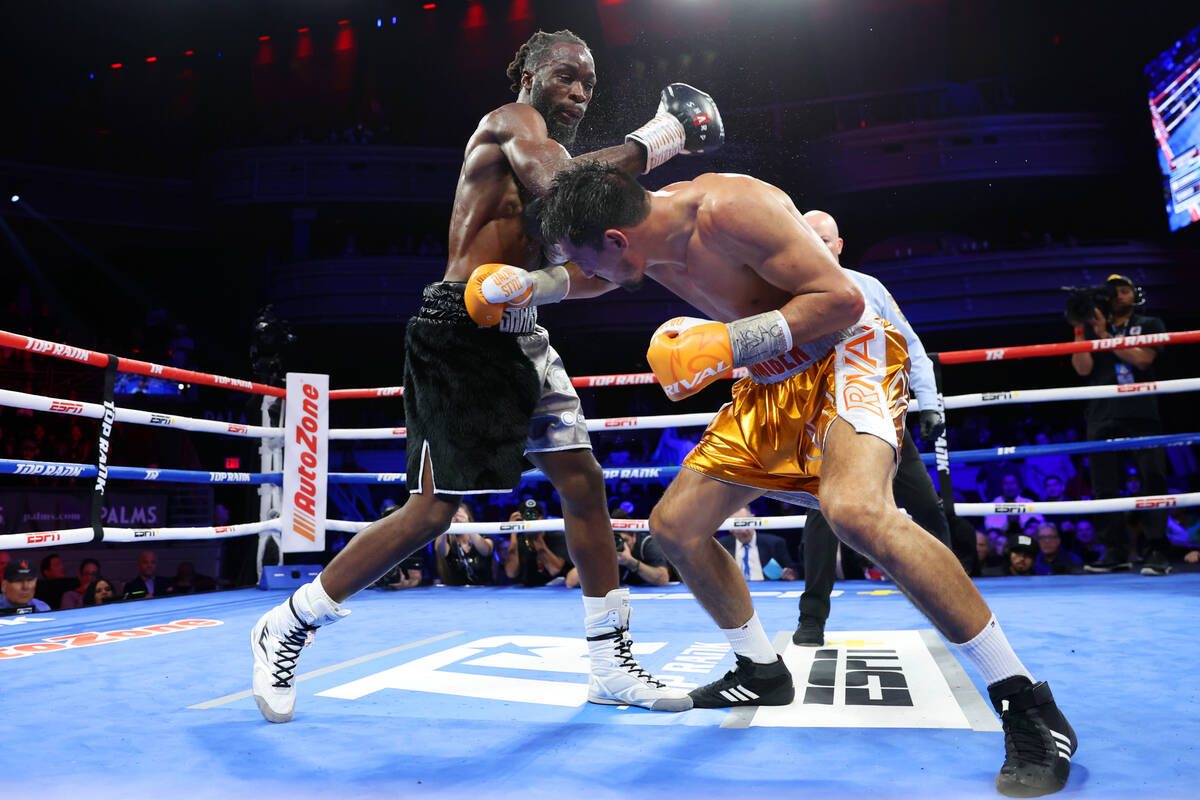 Janibek Alimkhanuly, right, dodges a punch against Denzel Bentley in the 12th round of a WBO mi ...