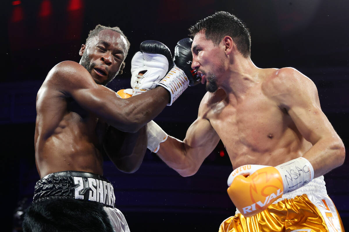 Janibek Alimkhanuly, right, connects a punch against Denzel Bentley in the eight round of a WBO ...