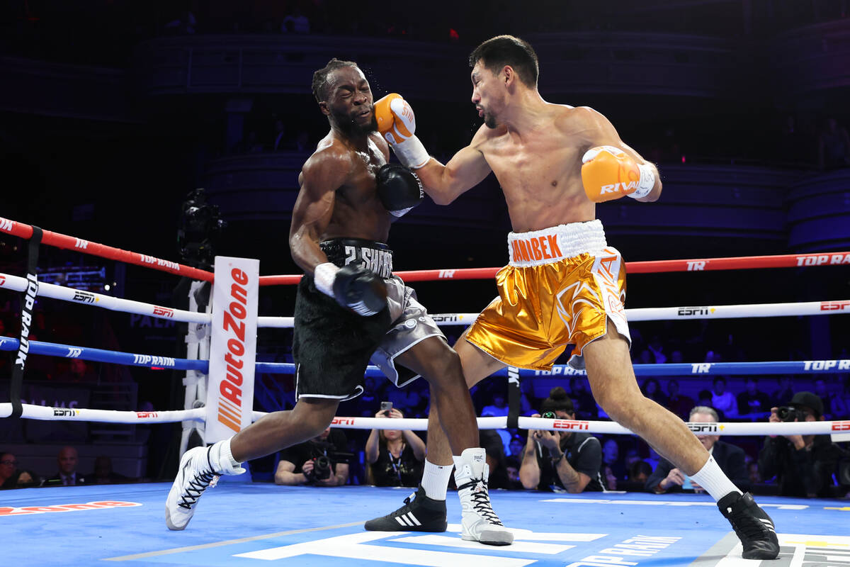 Janibek Alimkhanuly, right, connects a punch against Denzel Bentley in the third round of a WBO ...
