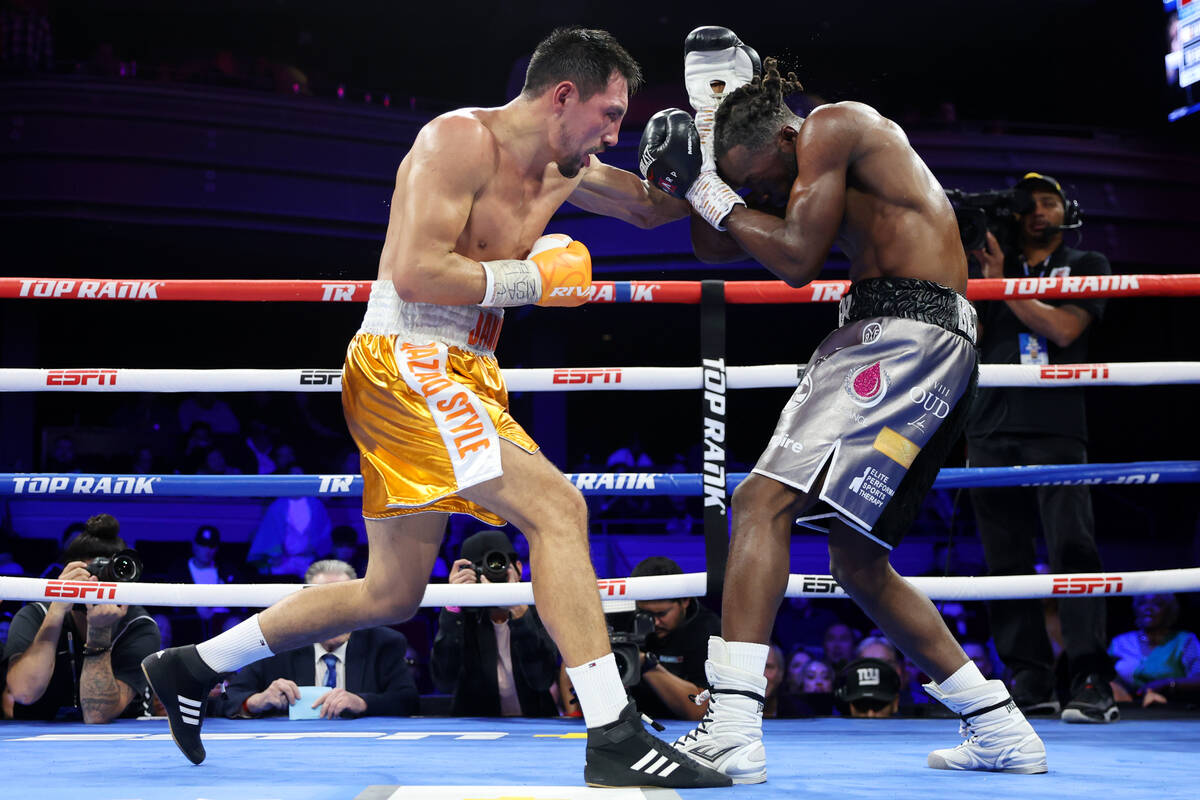 Janibek Alimkhanuly, left, connects a punch against Denzel Bentley in the 11th round of a WBO m ...